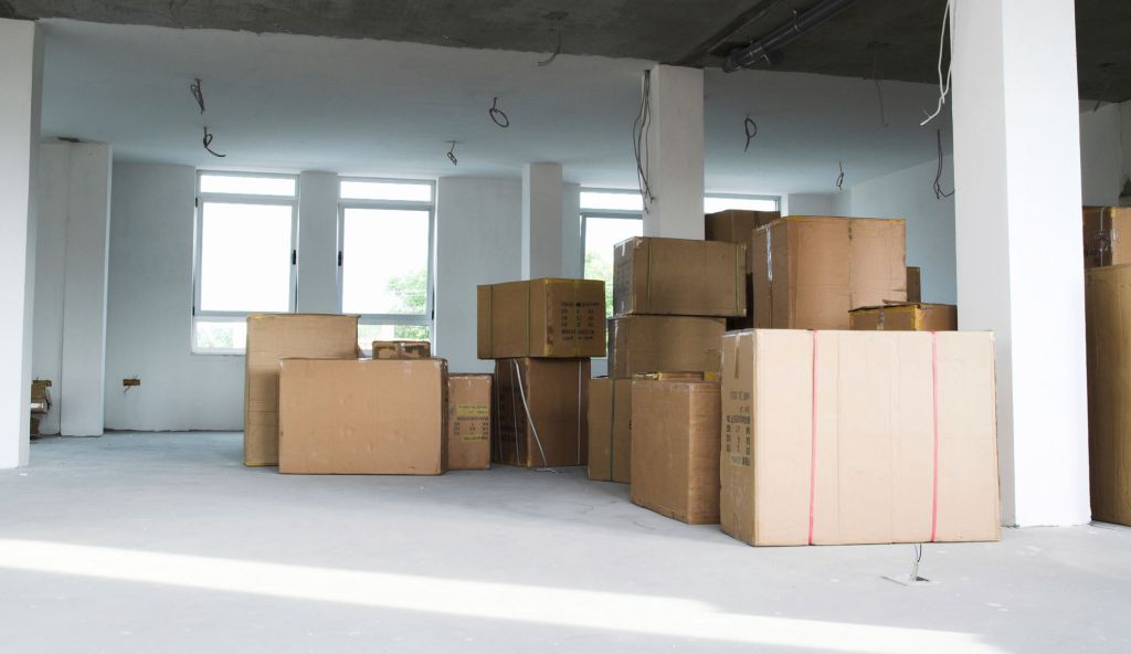 Office with boxes in it that are packed with office equipment, in preparation for an office move